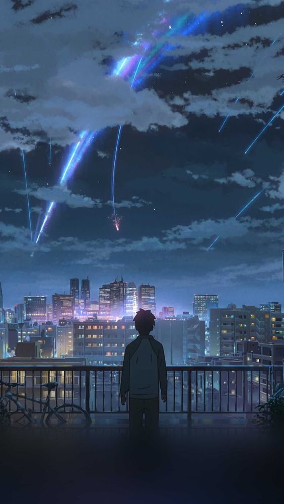 Anime character looking at city at night.