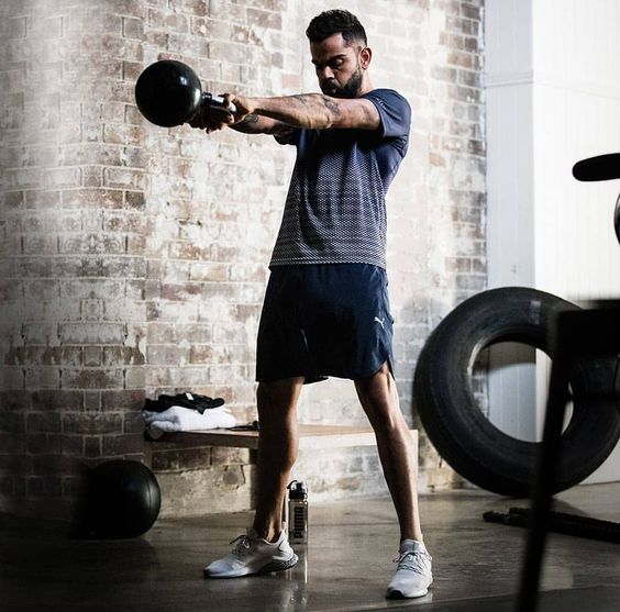 Virat Kohli exercising with kettlebells