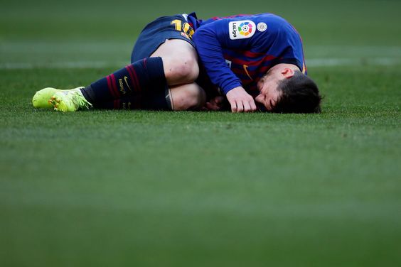 Lionel Messi on ground in pain