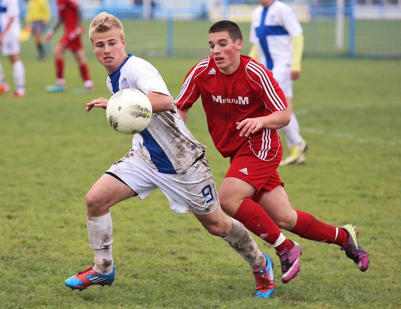 Two young boys playing football